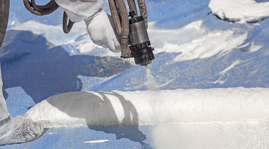 Diversified Roofing | someone spraying foam insulation
